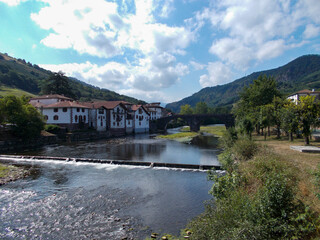 Fototapeta na wymiar Municipality of Elizondo, in the Baztán valley with the Bidasoa river and the water dam, in Navarra, Spain. Europe. Horizontal photography.