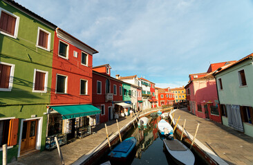Fototapeta na wymiar Venice landmark, Burano island canal, colorful houses and boats, Italy