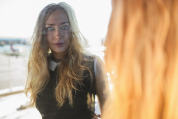 Portrait of a beautiful blonde girl. Reflection in the mirror.