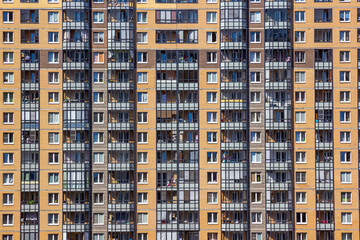 Fototapeta na wymiar Yellow Brick Facade in Daylight of Skyscrapers Apartment Buildings Residential Blocks Detail Texture Background Saint Petersburg City Russia