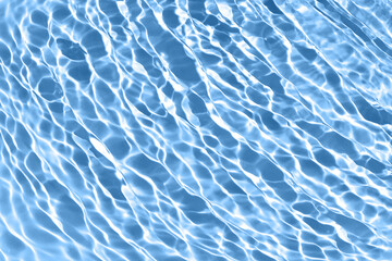 Transparent blue colored clear water surface texture with ripples, splashes and bubbles. Abstract...
