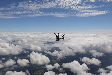 Obraz na płótnie Canvas Skydiving. Three skydivers are falling headdown together.