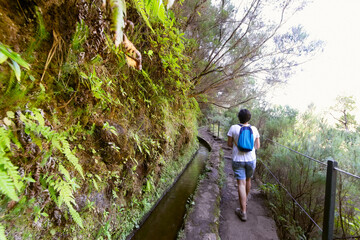 brave woman free in motion  in trekking hiking , Madeira island , 25 fontes and Risco routs