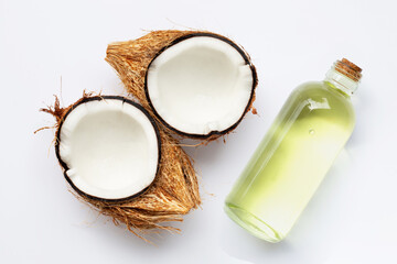 Coconut oil with coconuts on white background.