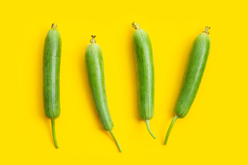 Fresh angled gourd on yellow background.