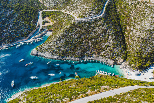 Aerial view of Porto Vromi with many fisher and tourist pleasure boats in the blue bay. Zakynthos - Zante island, Greece