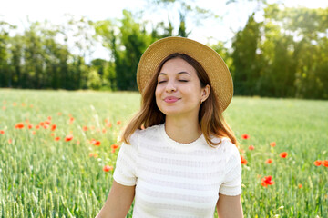 Peaceful girl with closed eyes breathe meditating in the fields