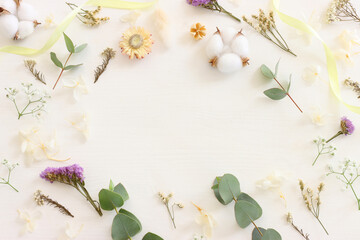 Top view image of flowers composition on white wooden background .Flat lay