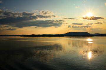 Obraz premium Beautiful sunrise over the ocean with sunlight shining over the clouds, Sognefjord, the country’s longest and deepest fjord, Close to Bergen, Norway, Baltic cruise on the North Sea.