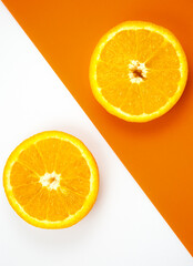 Close up photo of Orange Fruit on the white and orange background. Citrus cut in half, inside, macro view. Minimalism, original and creative image. Beautiful natural wallpaper.