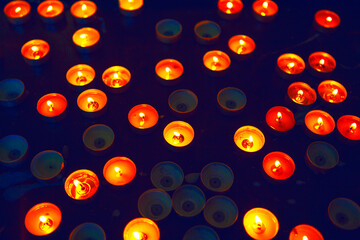 Burning round candles in the dark room . Place for praying 
