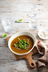 Homemade lentil soup with fresh spinach and seeds