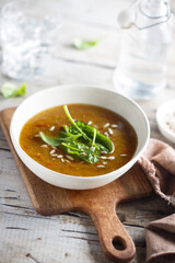 Homemade lentil soup with fresh spinach and seeds