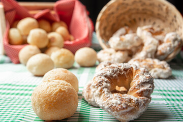 Brazil cheese bread and sweet biscuit on a table with green checkered tablecloth, selective focus.