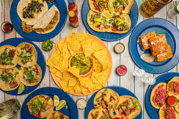 Set of popular Mexican gastronomy dishes. Tacos al pastor, corn nachos with guacamole, cochinita pibil tacos, corn cake, chicken tinga tacos.