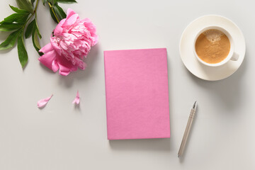Creative female mockup with coffee cup, pink peony flowers, sketchbook. Copy space. View from above, flat lay.