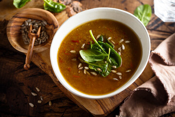 Homemade lentil soup with fresh spinach and seeds