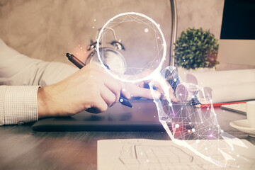 Double exposure of man's hands holding and using a mobile device and creative hologram drawing.