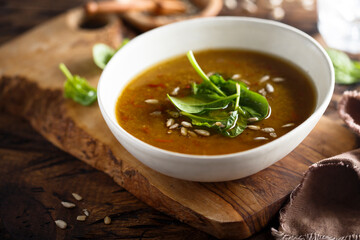 Homemade lentil soup with fresh spinach and seeds
