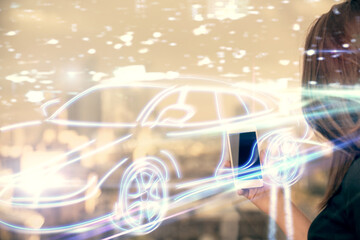 Double exposure of automobile icon hologram and woman holding and using a mobile device. Technology concept.
