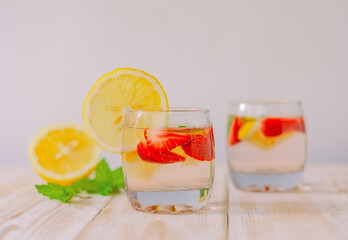 strawberry, lemon and mint with soda. strawberry-citrus summer cool beverage. lemon water with berries.