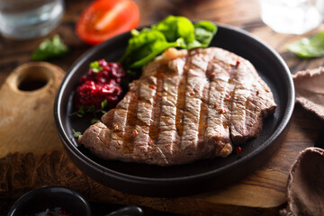 Grilled beef steak with fresh spinach