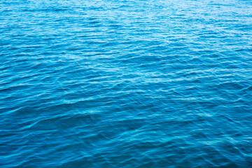 Blue water with sun reflections