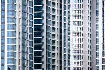 Close-up of many windows on a facade of new apartment building