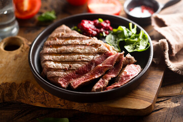 Grilled beef steak with fresh spinach