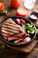Grilled beef steak with fresh spinach