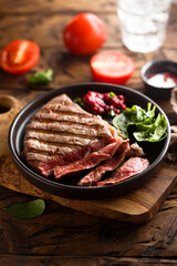 Grilled beef steak with fresh spinach