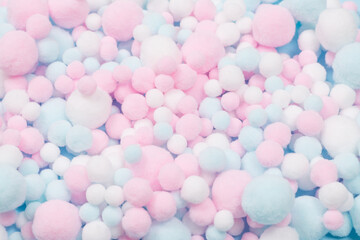 White, pink and blue soft pompons as a background.