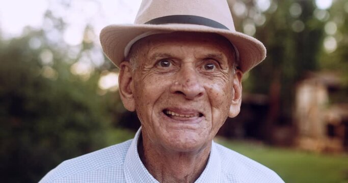 Smiling beautiful older male Latin farmer. Elderly man at farm in summer day. Gardening activity. Brazilian elderly man. 4K.