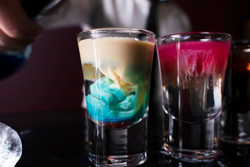 Cocktail shots at the bar counter. Cocktail at the bar. Alcoholic drink at the night club.