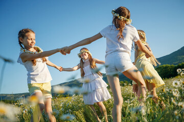 Children in nature. The girls play fun. High quality photo
