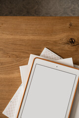 Fototapeta premium Blank screen display on wooden table. Flat lay, top view minimalist blog, website, app template. Copy space mockup.