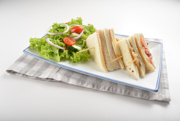 assorted sandwiches club with ham, cheese and mayo egg with salad in white background western halal menu