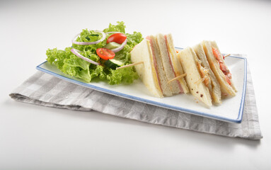 assorted sandwiches club with ham, cheese and mayo egg with salad in white background western halal menu