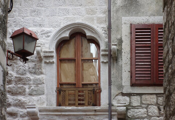 Fototapeta na wymiar old window with arches in a stone wall and a street light, Korcula, Croatia 