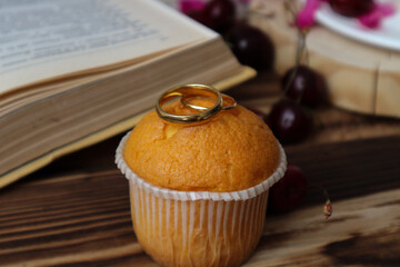 a cake with two wedding rings, an invitation to a wedding