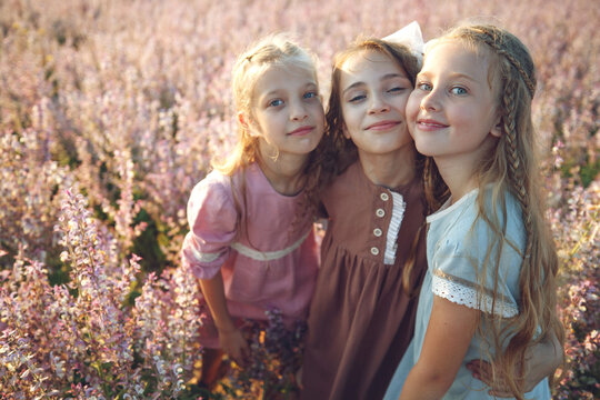 Girls girlfriends in a field with flowers. High quality photo