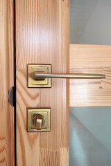 Wooden door with glass, handle and lock.