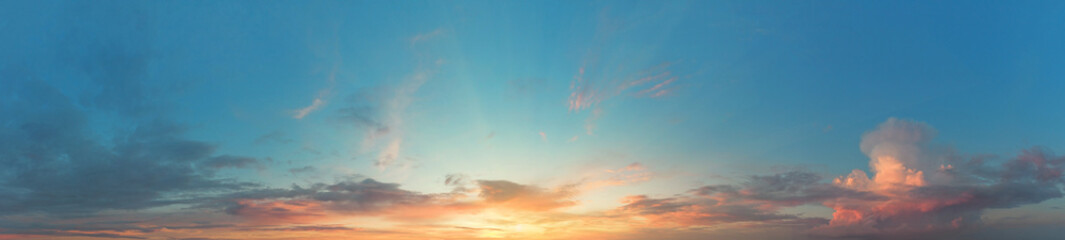 Panorama of turquoise sky with setting or dawn sun
