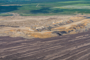 Aerial view of an open pit mine in Germany with brown coal digging by giant excavators 