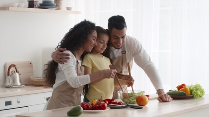 Joyful Arabic Family Cooking Making Vegetable Salad Together In Kitchen