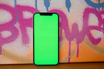 Phone with green screen. Smartphone. Mockup. Green background. Beautiful photo of the phone
