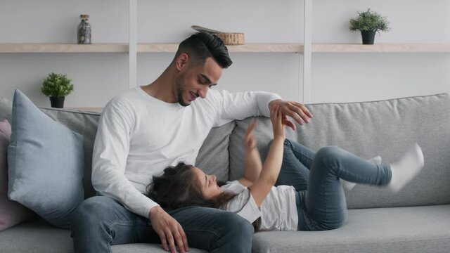 Middle-Eastern Father Tickling Little Daughter Having Fun Together At Home