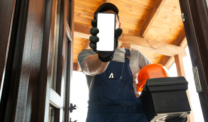 the handyman showing the phone with blank white screen in the home entrance