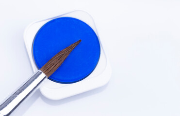 The image shows blue watercolor isolated with brush on white background