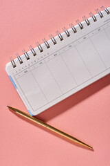 opened blank personal organizer on pink background
